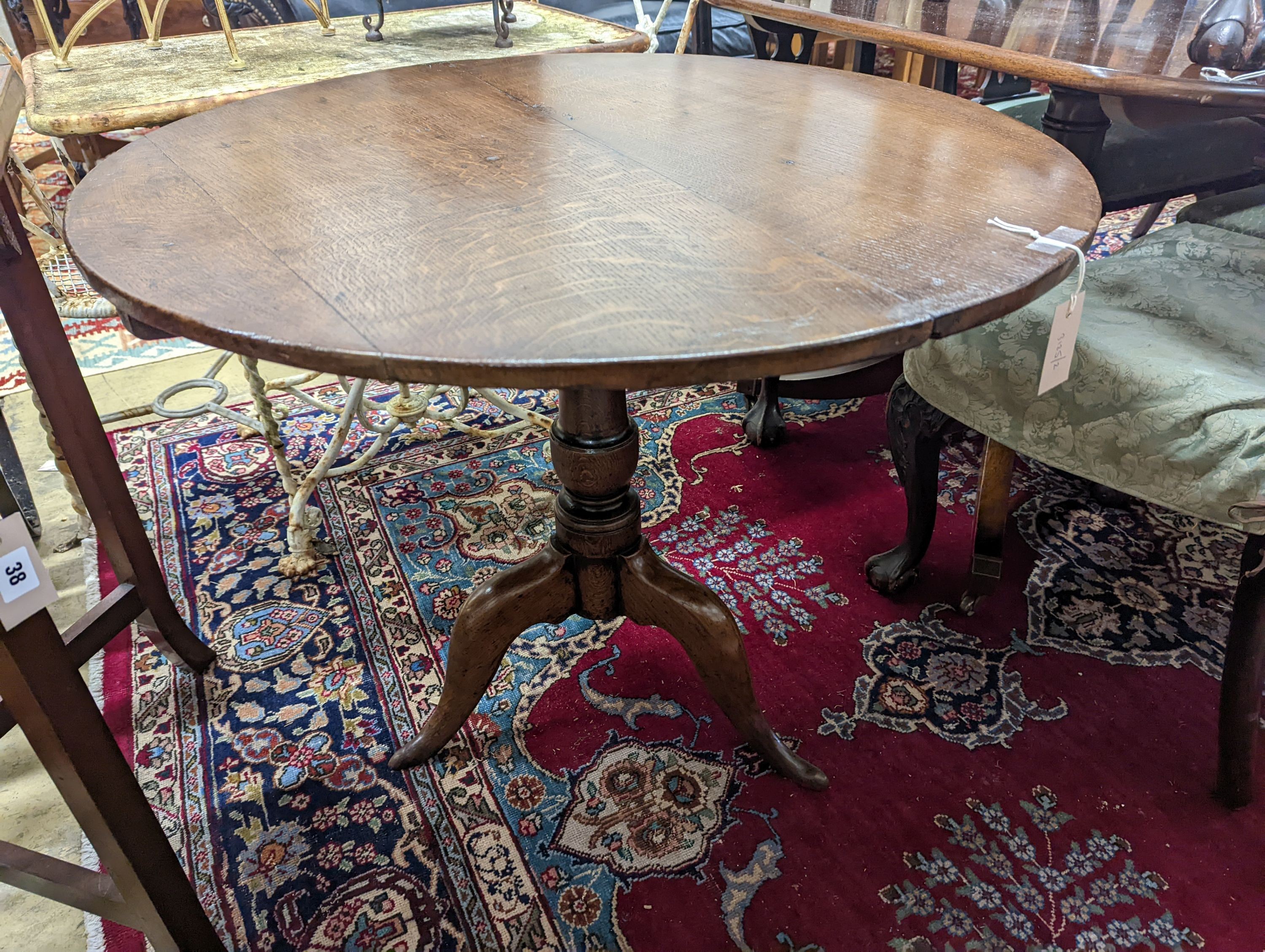 A George III circular oak tilt top tea table, diameter 86cm, height 71cm